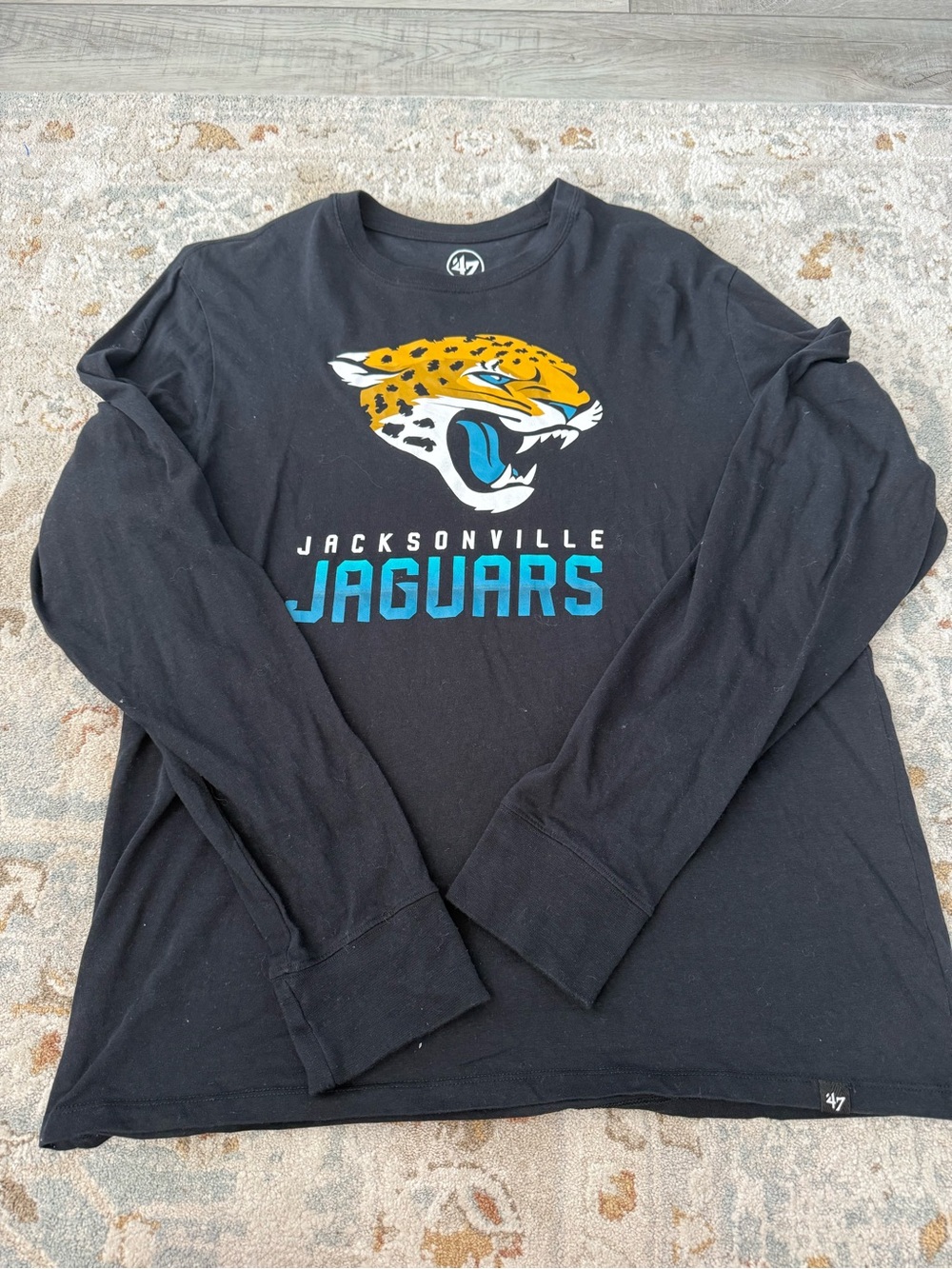 47 Jacksonville Jaguars Black Long Sleeve Graphic Tee with Teal Logo